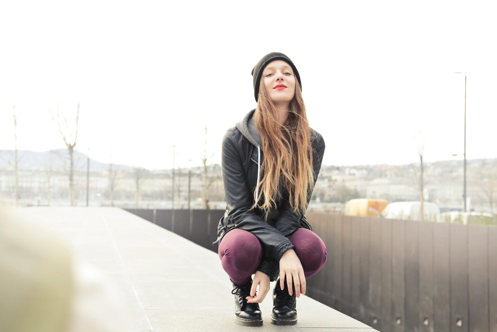 Fashionable young woman poses outdoors in Budapest with a stylish look.